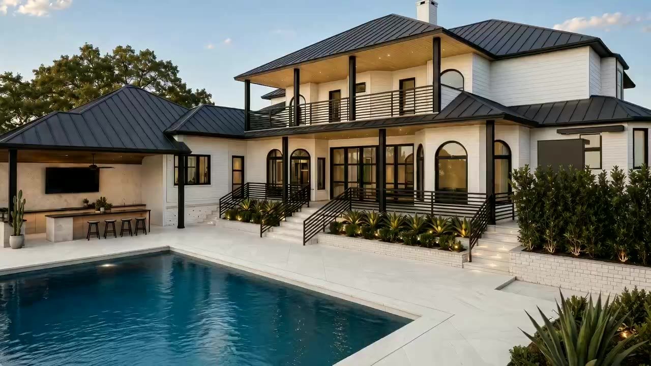 Rear elevation of a modern white-brick estate at golden hour with resort pool