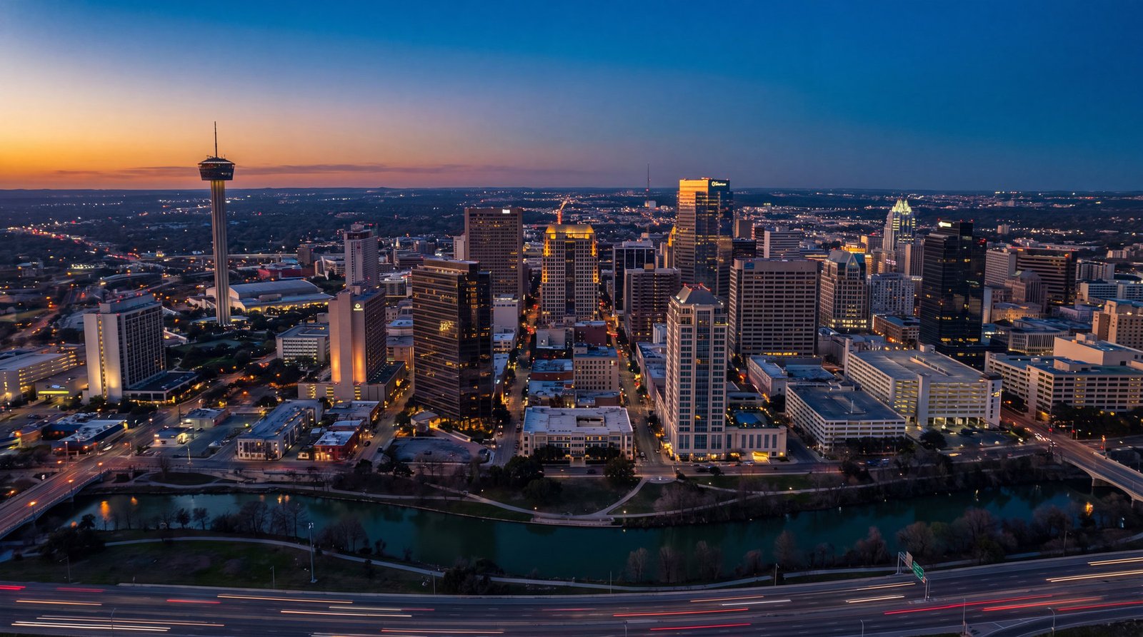 Downtown San Antonio skyline at dusk with the river in the foreground